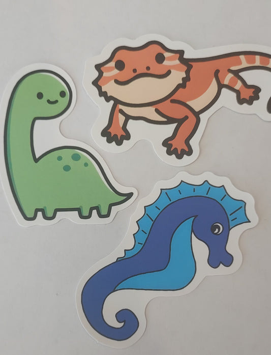 Random Animal Sticker, Reptile, Amphibian, Mammal, Aquatic, Bird. Featured in photo: Green Dinosaur, Orange Salamander, Blue Seahorse